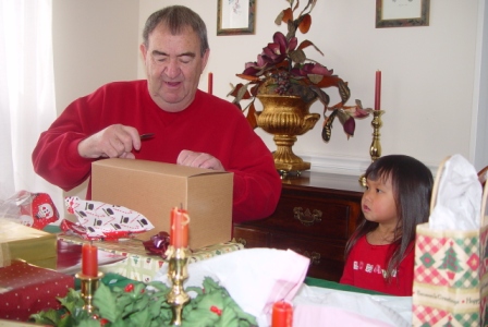 Kasen watching Papa open the present she made